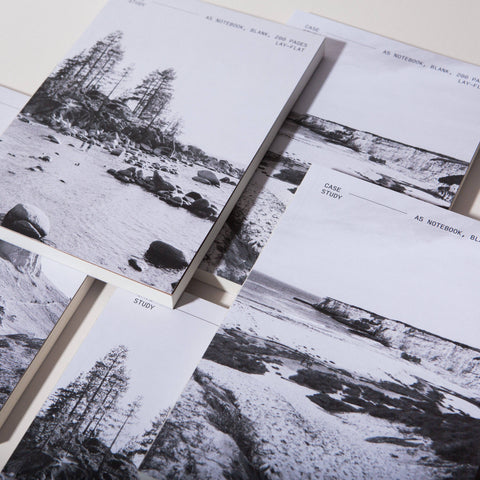 Stack of overlapping Case Study notebooks whose covers feature black and white photographs of empty landscapes.