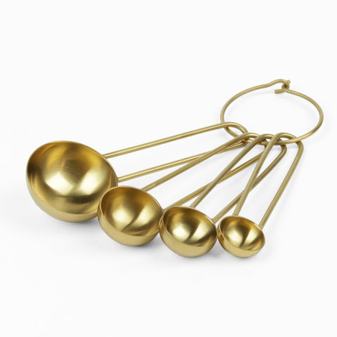 Five brass measuring spoons on a brass ring