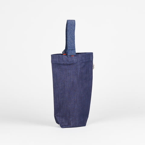 standing view of Aplat Denim wine tote with red detail stitching and adjustable strap