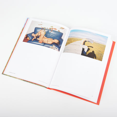 open book showing two photographs of a person in states of undress in Love Songs - Photography and Intimacy