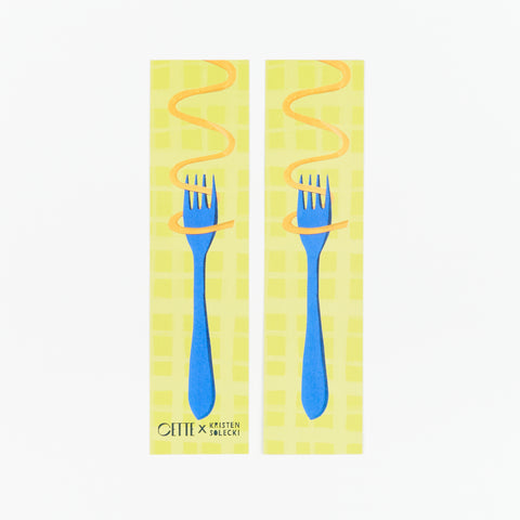 Front and back of a CETTE X Kristen Solecki illustrated bookmark showing a piece of orange spaghetti wrapping around a blue fork