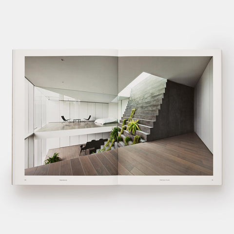 interior of an open plan modernist home with plants growing up the wall in Japanese Interiors