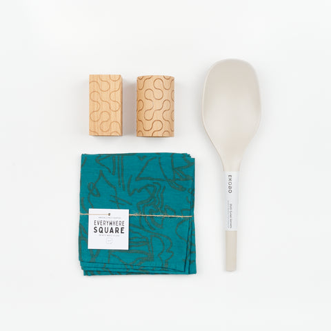 Areaware Pattern Salt and Pepper Shakers, a set of Stone colored Bamboo serving spoon, and a blue green Jenny Pennywood cotton linen Everywhere Square