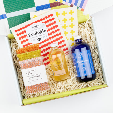 colorful gift box with warm tone lurex sponges, red and yellow pattern Swedish dish cloths, Fillaree hand soap reusable bottle and Clean Dream spray