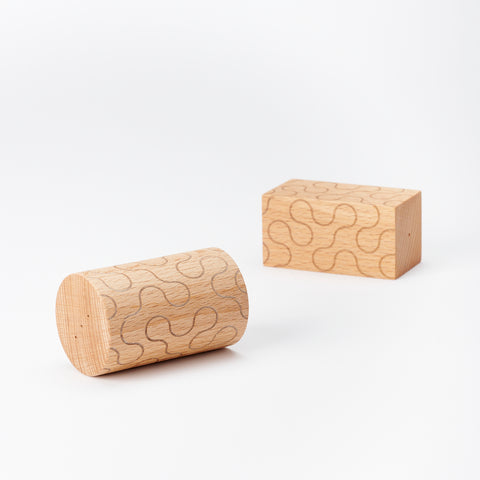 pair of Areaware shakers laying on their sides