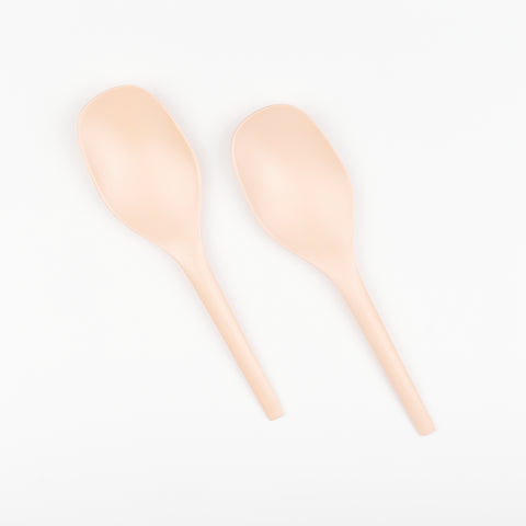 a pair of blush pink minimalist salad serving spoons