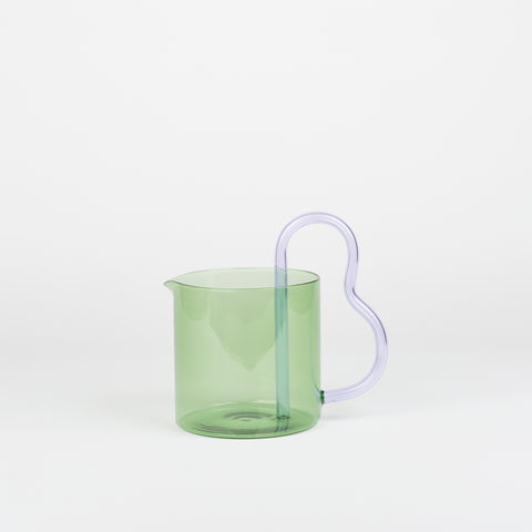 Green glass pitcher with a lilac handle by Sophie Lou Jacobsen