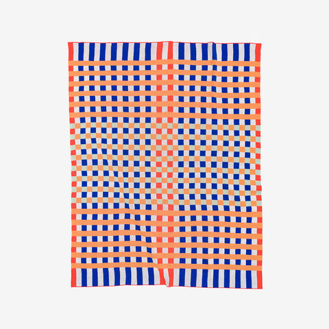 Verloop cotton knit throw with checkerboard pattern in poppy and cobalt