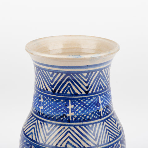 the top half of a handmade ceramic vase with a blue cross-hatch hand-drawn pattern