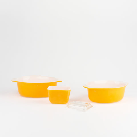 three vintage yellow serving bowls of varying sizes