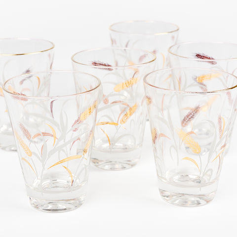 close up of vintage short wheat-themed juice glasses