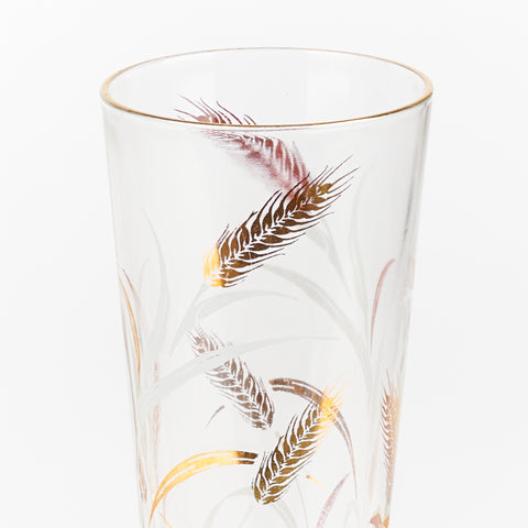 detail of golden wheat pattern on tall glass