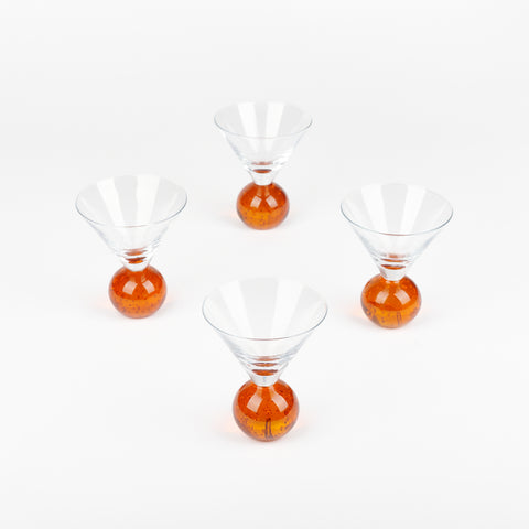 Four vintage martini glasses arranged in a diamond shape