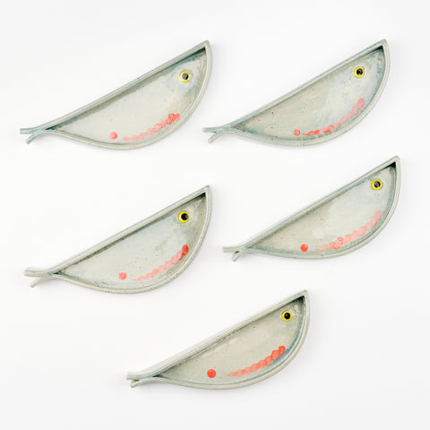 Five ceramic fish shaped dishes handmade by Libby Hruska