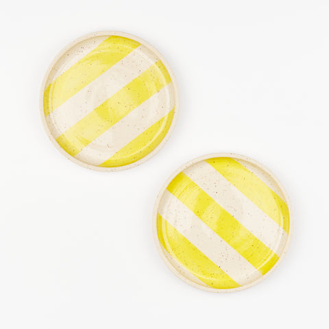 Two yellow striped speckled ceramic plates