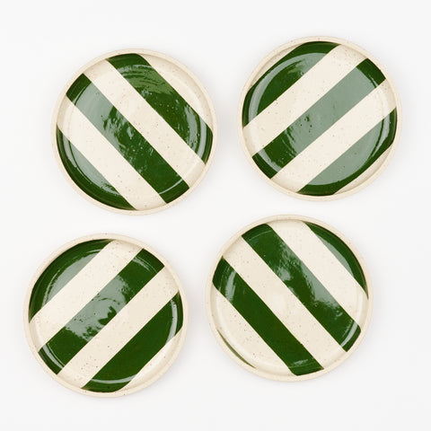 A set of four ceramic striped coupe plates with green stripes