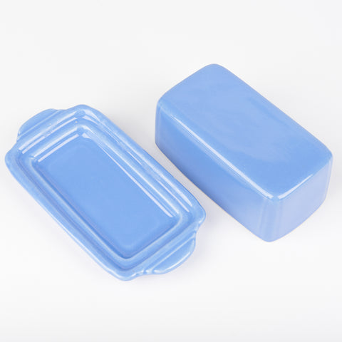 The top and bottom of blue Riviera ware butter dish with rounded edges