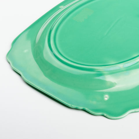 a close up of the underneath side of a vintage green dish
