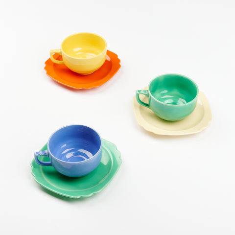 Three riviera ware tea cups and saucers arranged in a triangular shape