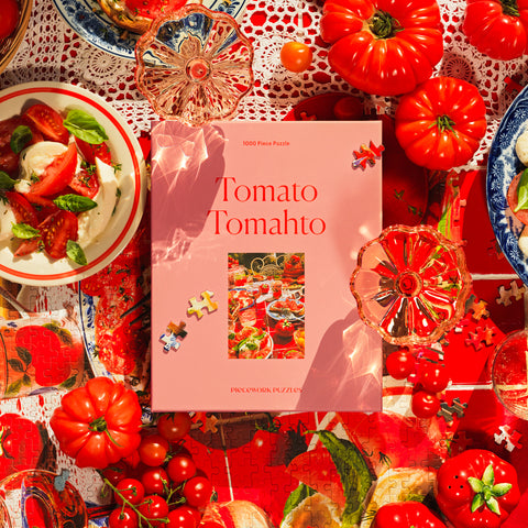 Tomato Tomahto Piecework Puzzle 1000 piece puzzle box surrounded by tomatoes, colorful glassware, and a caprese salad