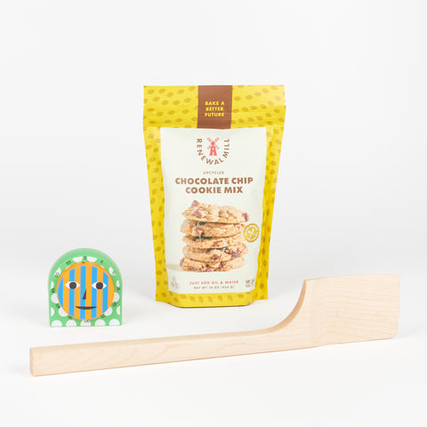 An Areaware Everybody Timer next to a bag of Renewal Mill Upcycled Chocolate Chip cookie mix and a Bad Dogs Studio Maple wood spatula