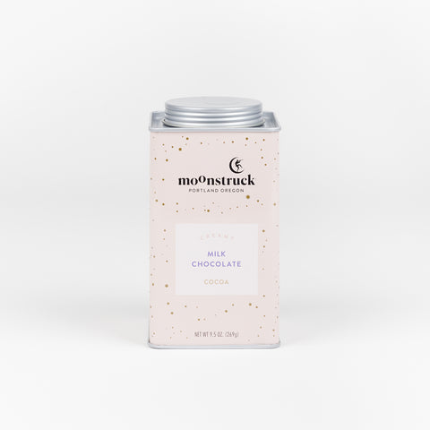 A pale pink tin of Moonstruck Creamy Milk Chocolate cocoa mix