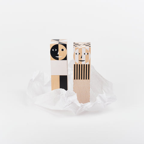 Areaware limited edition grinders with smiling shape faces poping out of a crinkle of white tissue paper