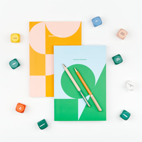 A gift set which includes two Poketo lined notebooks, a set of Papier ballpoint pens and Writing Dice to provide inspiration for creative writing