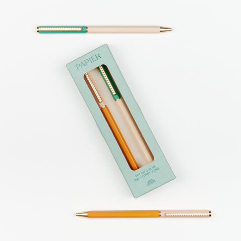 Set of Papier slim 2-color ballpoint pens shown inside and outside the packaging on a white background.