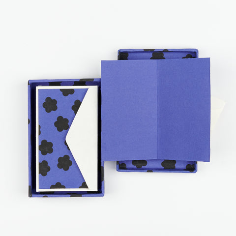 an open box of Hataguchi Collective purple blank notecards with a floral print