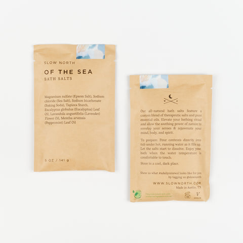 two brown paper packets of Slow North Bath Salts front and back of the packets are shown
