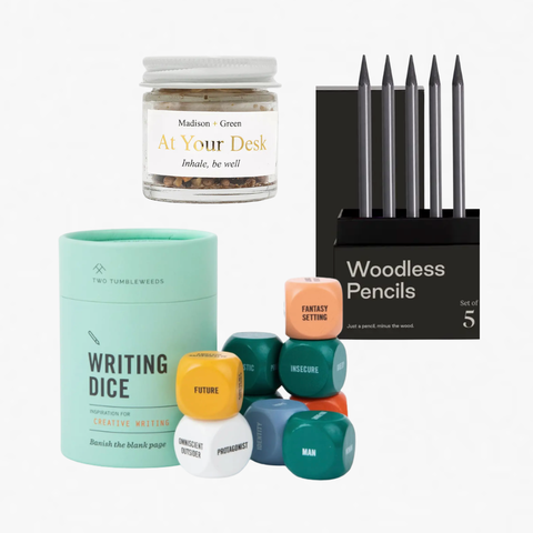 Collection of writing and desk accessories including writer's dice, an aromatherapy jar, and a set of woodless pencils on a white background