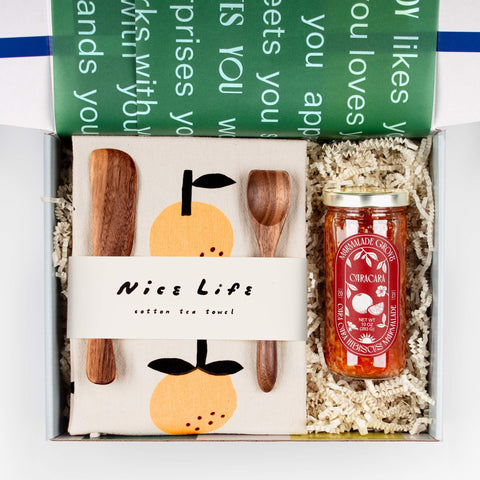Open Jam On It gift box displaying artisanal marmalade, tea towel, and walnut spreaders, beautifully arranged—ideal for thank you and host gifts.
