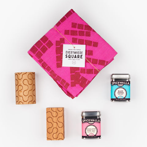 The Shake It Up gift set with Jenny Pennywood Everywhere Square textile in hot pink, Dusen Dusen wooden salt and pepper shakers, and Spicewalla spices.