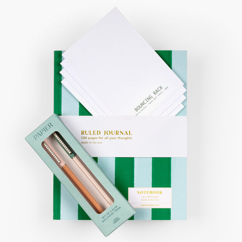 Natural Notes gift set with striped journal, back view of a set of art cards by Carolyn Fauteux, and Papier pen set arranged on white background.