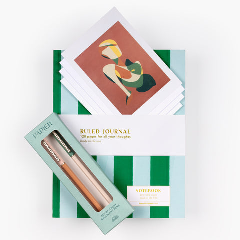 Natural Notes gift set with striped journal, set of 4 art cards by Carolyn Fauteux, and Papier pen set arranged on white background.