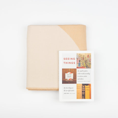 A Book and Blanket Gift set including a Manifatura wool throw blanket in Crema and the DAP ArtBook Seeing Things - The Small Wonders of the World