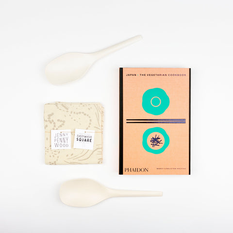 White EKOBO bamboo serving spoons, Phaidon Cookbook -Japan: The Vegetarian Cookbook, and a Jenny Pennywood Everywhere Square in natural and fog