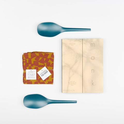 EKOBO Blue Abyss bamboo serving spoons, Phaidon Cookbook - Monk: Light and Shadow on the Philosophers Path, and a Jenny Pennywood Everywhere Square in a checks pattern in maroon and ocher