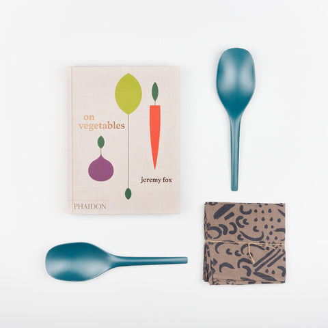Blue Abyss EKOBO bamboo serving spoons, Phaidon Cookbook - On Vegetables by Jeremy Fox, and a Jenny Pennywood Everywhere Square in walnut and midnight