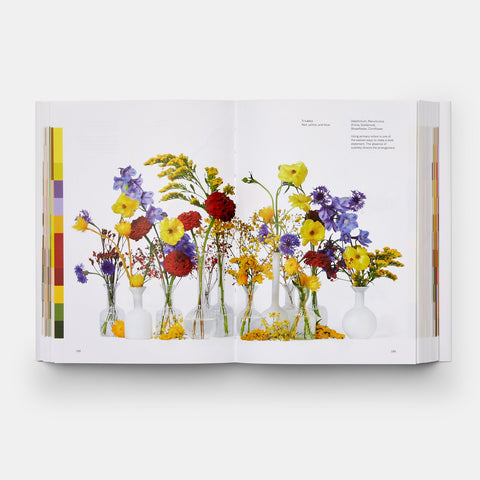 Flower Color Theory book open to a page with yellow, red, purple and orange flowers