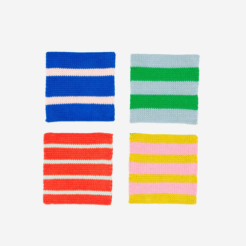Four knitted swatches with different color patterns on a white background, part of the Pop of Color gift set.
