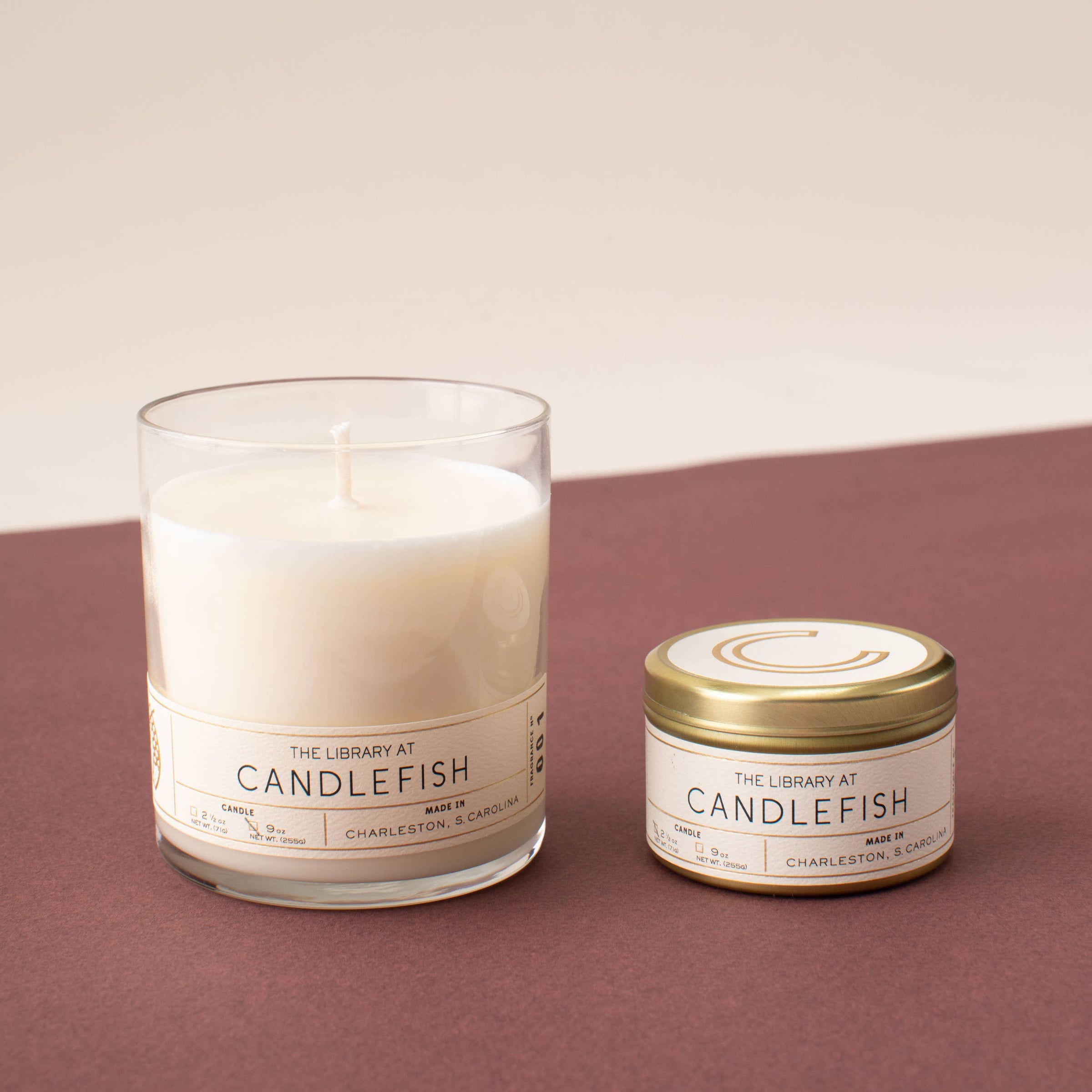 Candlefish full-size glass candle and travel tin candle on brown background. Tin included in the Kindled Comfort gift set.