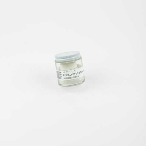 A glass jar of shower steamers