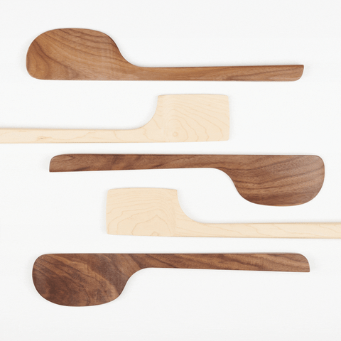 an animated gif showing five wooden spatuals moving left to right like waves in the ocean