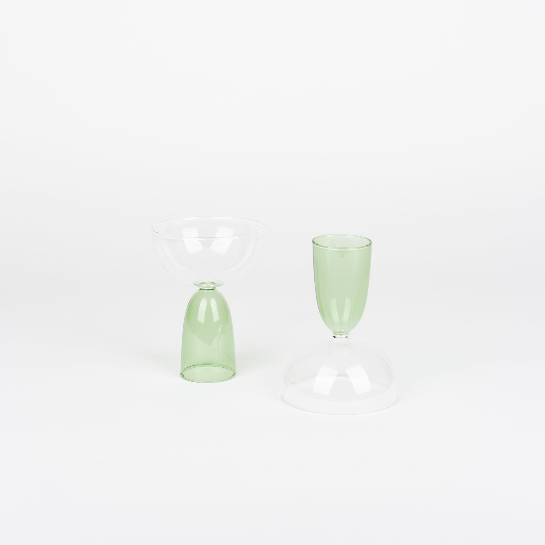 pair of Mamo coupe glasses with green bases and one is turned upside down
