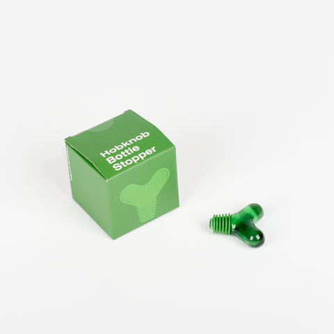 Green Areaware Hobknob Bottle Stopper with green box beside it