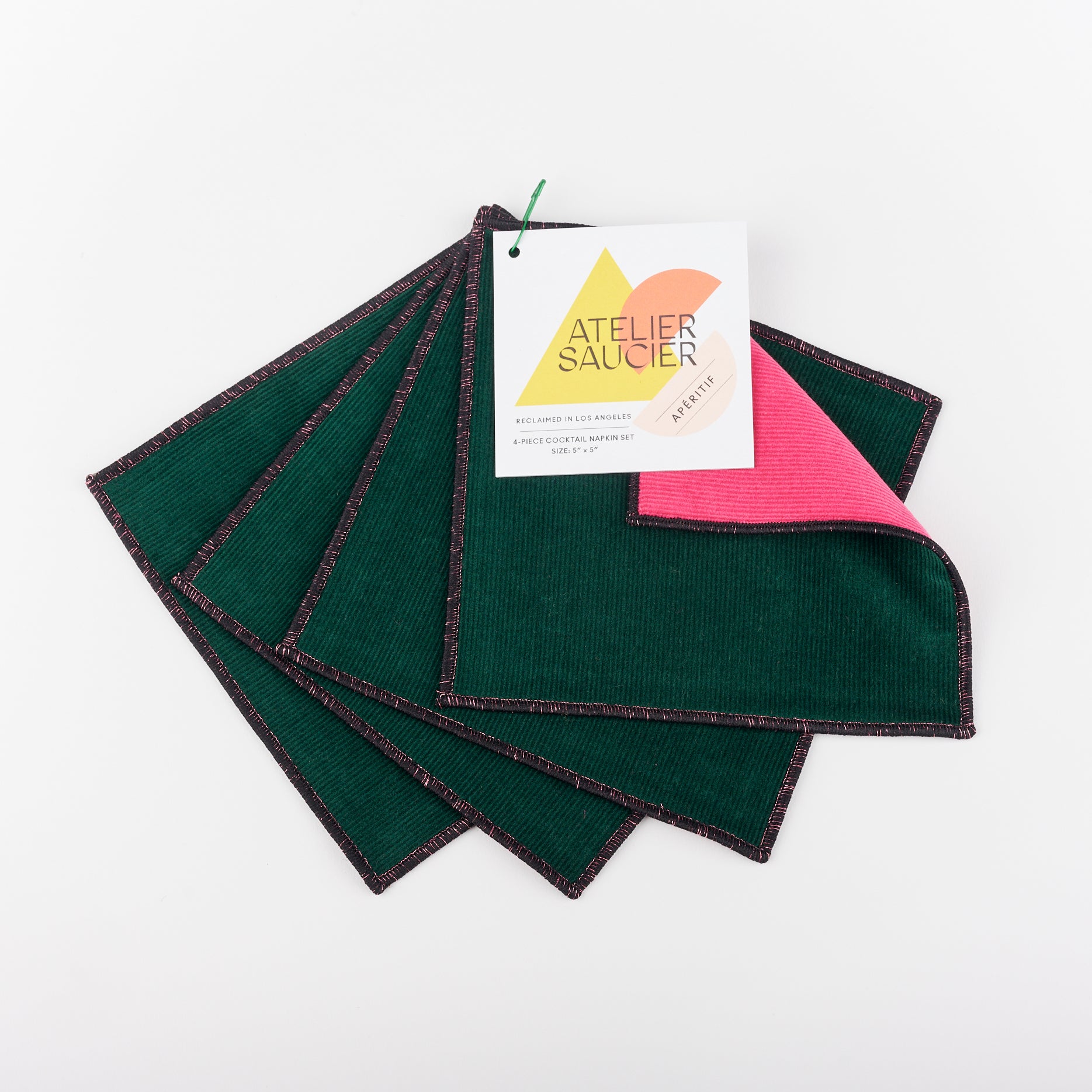 Cocktail napkin set by Atelier Saucier - one side dark green and the other side light hot pink with metallic edges
