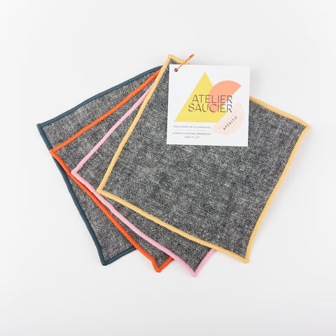 Set of four Atelier Saucier grey cocktail napkins with yellow, pink, red and teal edges
