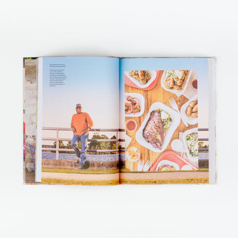 An open view of Edible North Carolina showing a picture of chef Ricky Moore and a table of various fish meals